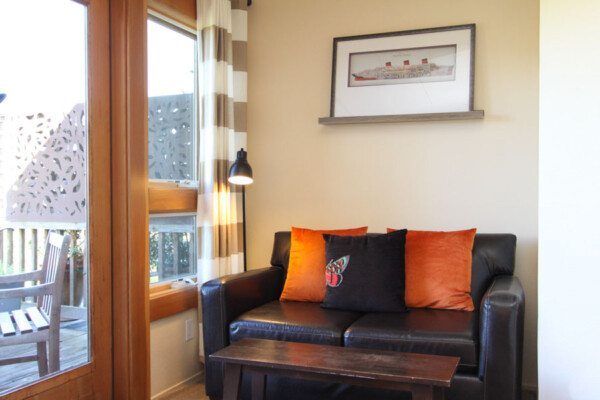 room with loveseat and pillows